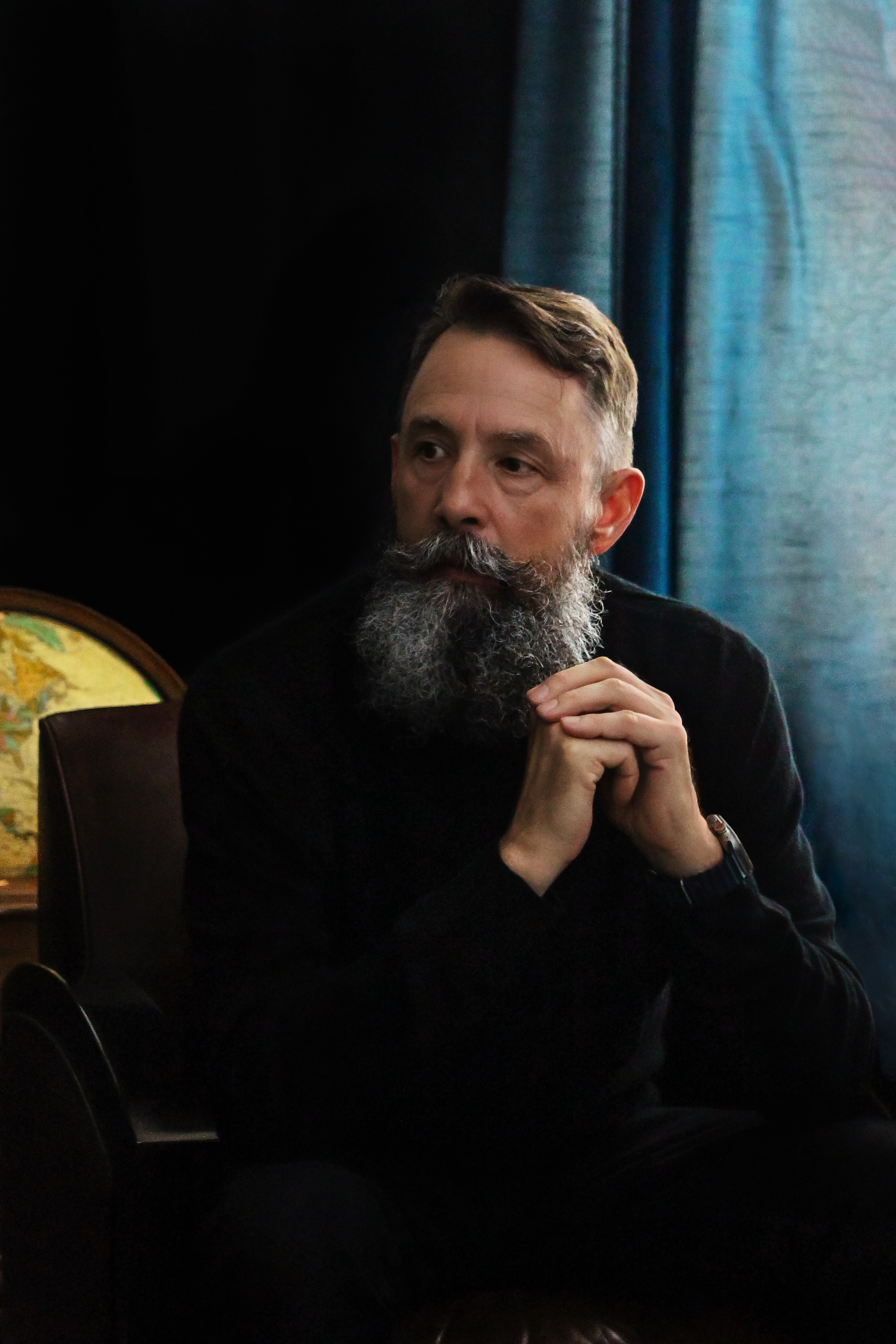 Shane Meche seated in his study